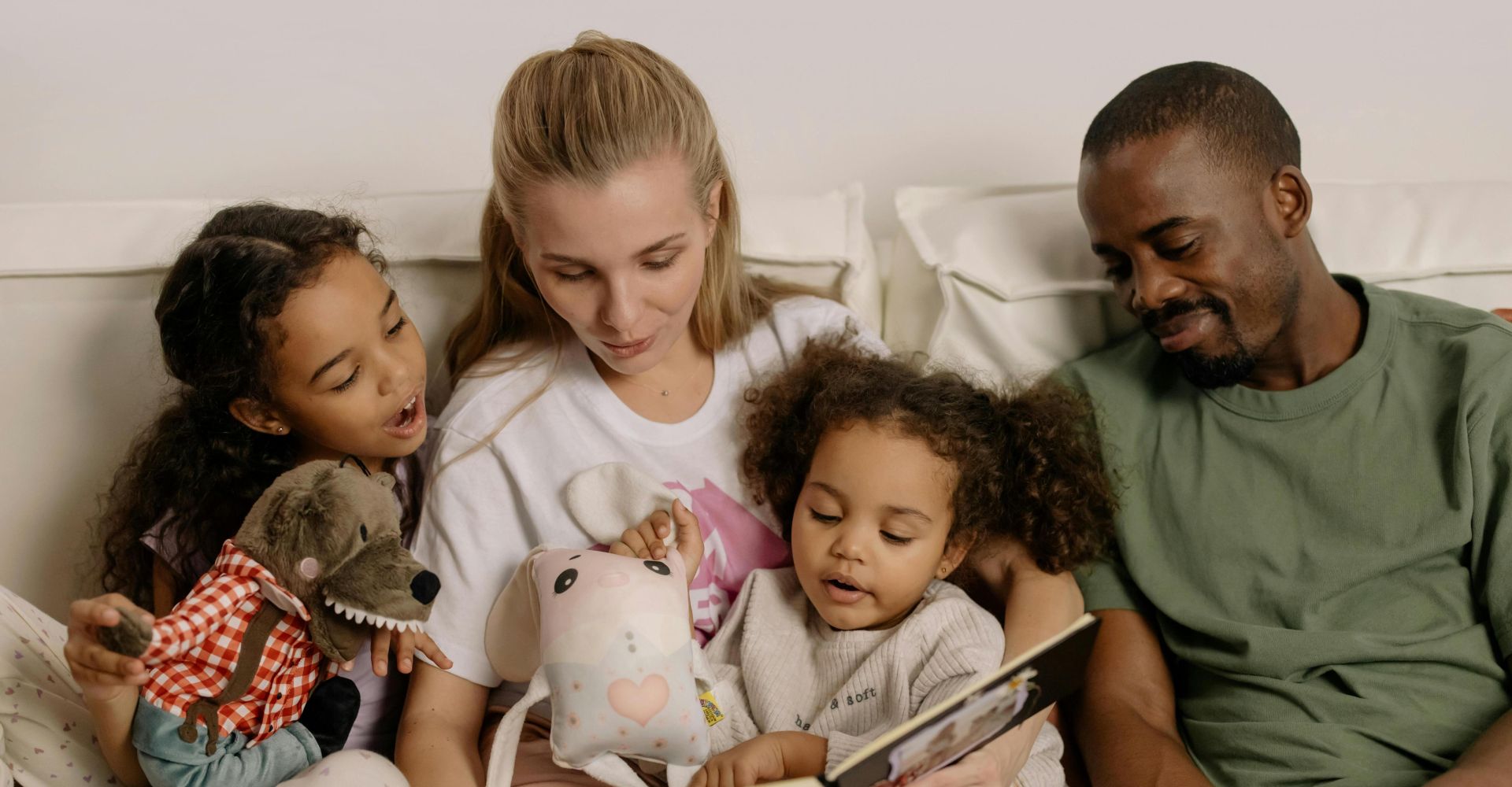 A diverse family enjoys reading a storybook together, fostering warmth and connection.